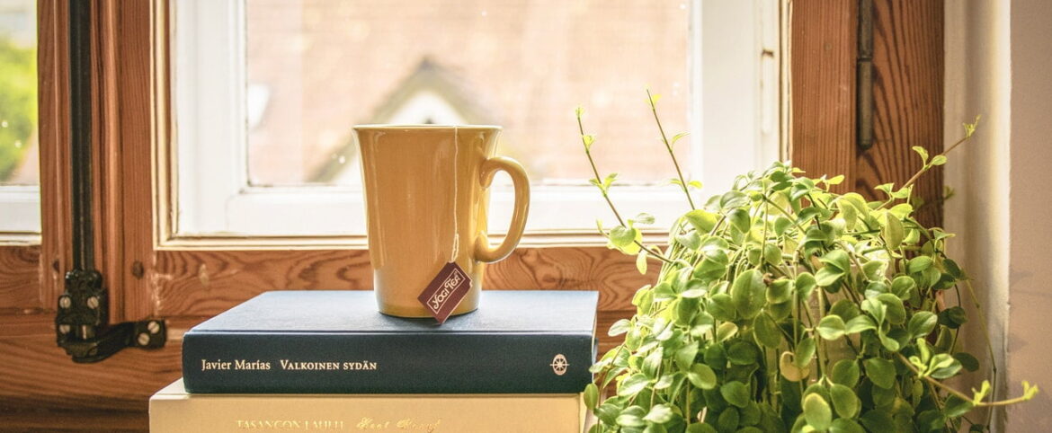 A coffee mug sitting on top of a book.