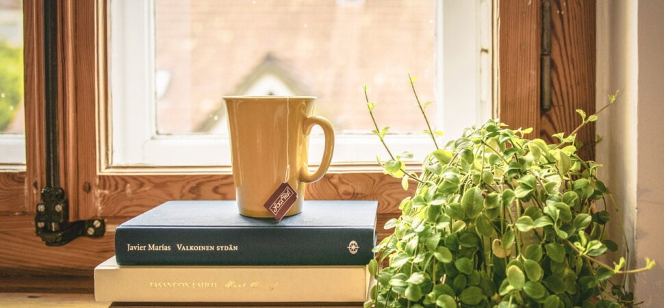 A coffee mug sitting on top of a book.